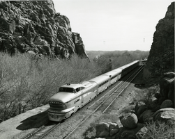 Photograph of a Union Pacific locomotive traveling through a canyon, 1956 to 1957