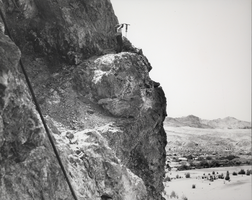 Photograph of a man working construction on a cliff near Black Canyon, Nevada, circa 1931