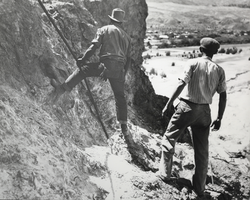 Photograph of men working construction on a cliff near Black Canyon, Nevada, circa 1931