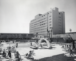 Photograph of guests in and out of the swimming pool at the Riviera Hotel, Las Vegas, circa 1950s