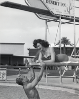 Photograph of a man and woman enjoying the swimming pool at the Royal Nevada Hotel, Las Vegas, circa 1950s