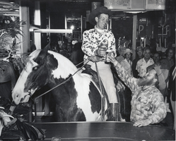 Photograph of a man on a horse in a the Fremont Hotel bar, Las Vegas, circa 1950s