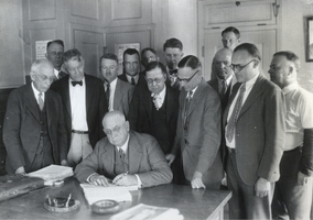 Photograph of several officials signing the contract to construct Hoover Dam, April 1931