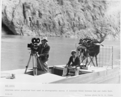 Film transparency of men with photography equipment on the Colorado River, March 16, 1935