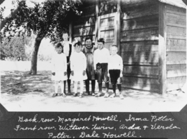 Film transparency of a group portrait in front of a wooden cabin, presumably in Las Vegas, 1916