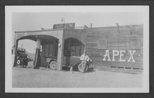 Photograph of a man and dog in front of the Apex Service Station, Apex, Nevada, circa 1930s-1940s