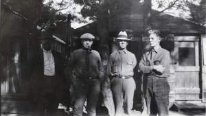 Photograph of men outside of a cabin, circa early 1900s