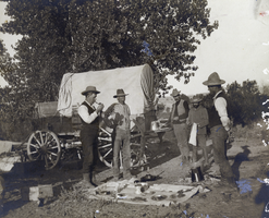 Photograph of railroad surveyors next to wagon, circa 1890s-1910