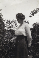 Photograph of a woman in a garden, circa early 1900s