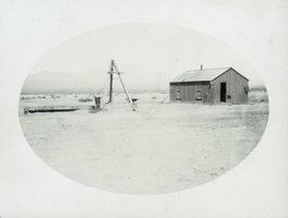 Photograph of wooden building in desert, circa 1890s-1910