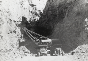 Photograph of two men operating heavy equipment on the Hoover Dam construction site, 1931