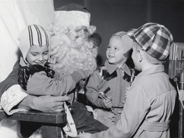 Film transparency of three children sitting on Santa Claus's lap, possibly Nevada, circa 1948-1950