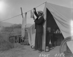 Film transparency of man hanging laundry, Las Vegas, 1931