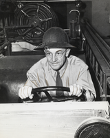 Film transparency of Leo Dunbar driving a work cart, unknown location, circa 1950s-1980s