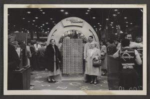Postcard of Mayme Stocker with Marion and Herbert Hyatt in front of the million dollar display at the Horseshoe Casino on Fremont Street in Las Vegas, Nevada, circa 1960-1972