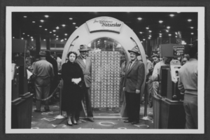 Postcard of Harold Stocker, Geraldine Stocker, and an unidentified man in front of the million dollar display at the Horseshoe Casino on Fremont Street in Las Vegas, Nevada, circa 1960-1972