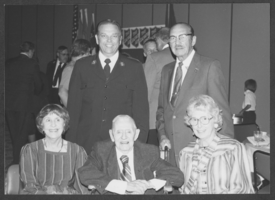 Photograph of Harold Stocker with unidentified people at a Salvation Army Award Banquet, 1982