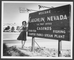 Photograph of a woman posing by a Laughlin, Nevada welcome sign, circa 1980s