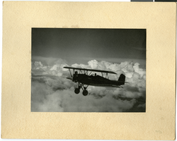 Photograph of a biplane in flight, circa 1910s-1930s