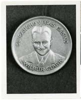 Photograph of a commemorative coin bearing the image of Wilbur Clark, circa 1944-1945
