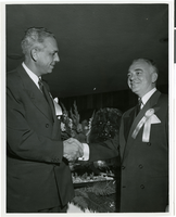 Photograph of Bob Stocking and Wilbur Clark at a party celebrating the first anniversary of the Desert Inn, Las Vegas, Nevada, April 1951