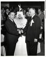 Photograph of Wilbur Clark with an unidentified man at the Desert Inn's first anniversary party, Las Vegas, Nevada, April 1951