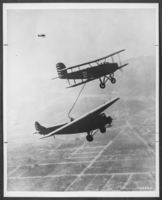 Photograph of an endurance flight plane being refueled in the air, January 1, 1929