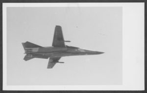Photograph of a swept-wing F-111 plane in the air, circa late 1960s to 1970s