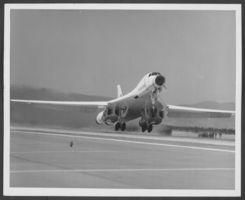 Photograph of an aircraft over the tarmac at Nellis Air Force Base, Nevada, circa 1970s to 1980s