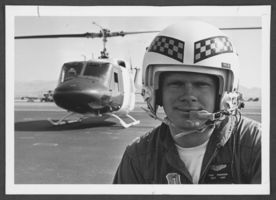 Photograph of Captain Dale Kissinger and his helicopter, Nellis Air Force Base, Nevada, July 22, 1976