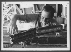 Photograph of Captain Frank Machovec with his electric train collection, Nellis Air Force Base, Nevada,  December 18, 1975