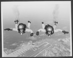 Aerial photograph of the Army's Golden Knights performing above Nellis Air Force Base, Nevada, March 25, 1983