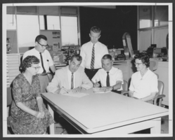 Photograph of postal clerks signing labor agreements, Las Vegas, August 26, 1963