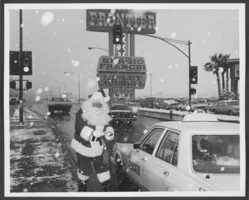 Photograph of a man in a Santa Claus costume across from the Frontier Hotel, Las Vegas, Nevada, 1974