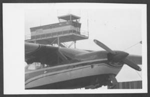 Photograph of a plane and the control tower at the North Las Vegas Air Terminal, North Las Vegas, Nevada, circa late 1960s