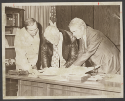 Photograph of Ralph Engelstad, Mayor Bud Cleland and Lieutenant Governor Ed Fike discussing a land gift, North Las Vegas, Nevada, December 27, 1974