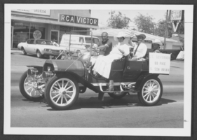 Photograph of Lieutenant Governor Ed Fike riding in a car entered in the North Las Vegas 25th anniversary parade, North Las Vegas, Nevada, April-May, 1971
