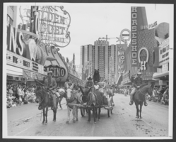 Photograph of a people, horses and donkeys in a parade on Fremont Street in downtown Las Vegas, Nevada, circa 1960s