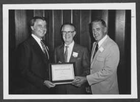 Photograph of people holding a Lifetime Honorary Membership certificate, Las Vegas, December 30, 1976
