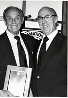 Photograph of Carl Cohen receiving an award from an unidentified man, circa 1970s-1986