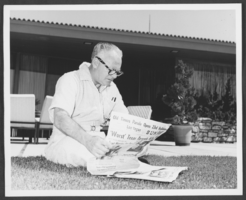 Photograph of Wilbur Clark sitting on his lawn reading a newspaper, Las Vegas, Nevada, 1957