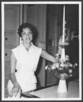 Photograph of Toni Clark displaying a centerpiece in her home, Las Vegas, Nevada, circa 1950s