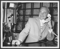 Photograph of Wilbur Clark answering the telephone at his home in Las Vegas, Nevada, 1957