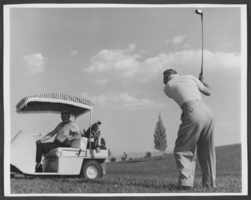 Photograph of Wilbur Clark swinging a golf club at the Desert Inn Golf Course, Las Vegas, Nevada, circa 1950s