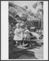 Photograph of children with fool cellar in background, Pioche, Nevada, circa 1921