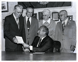 Photograph of Elbert Edwards and others with an accompanying letter, April 24, 1975