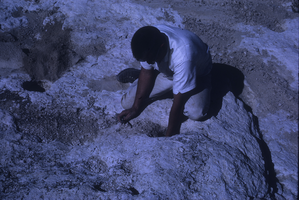 Slide of man grinding holes, Old Spanish Trail, Nevada, circa 1960s - 1983