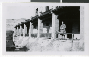 Photograph of Frank Garside posing in front of the Rhyolite Depot, Las Vegas, circa 1920s