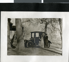 Photograph of Mr. and Mrs. John S. Park entering a car, circa 1920s to 1930s