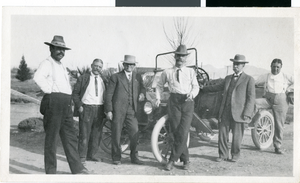 Photograph of a group of men and a car, circa 1910s to 1920s